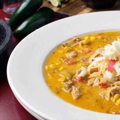We offer spicy chicken in a cheesy tortilla soup topped with tortilla strips